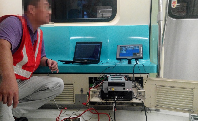 The engineer is performing a field test on the EverFocus mobile system for a cabin on the Taipei Metro System.